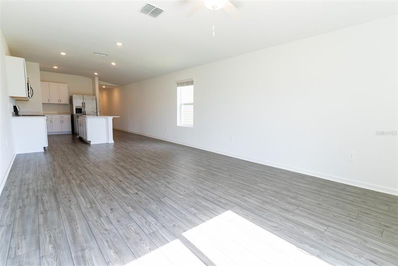 Open-concept living room flowing into the kitchen