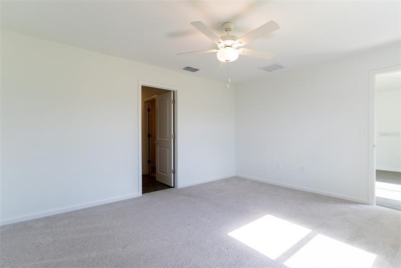 Primary bedroom with ceiling fan